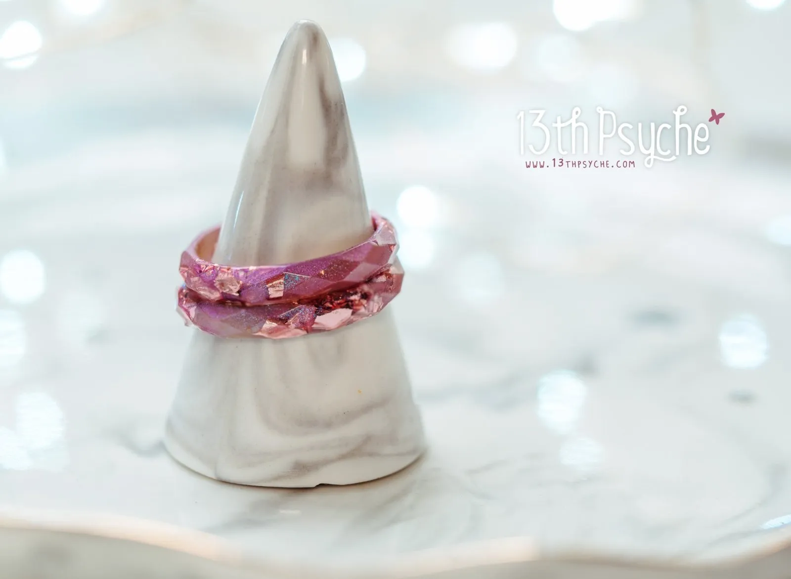 Iridescent pink faceted resin ring with pink metal flakes